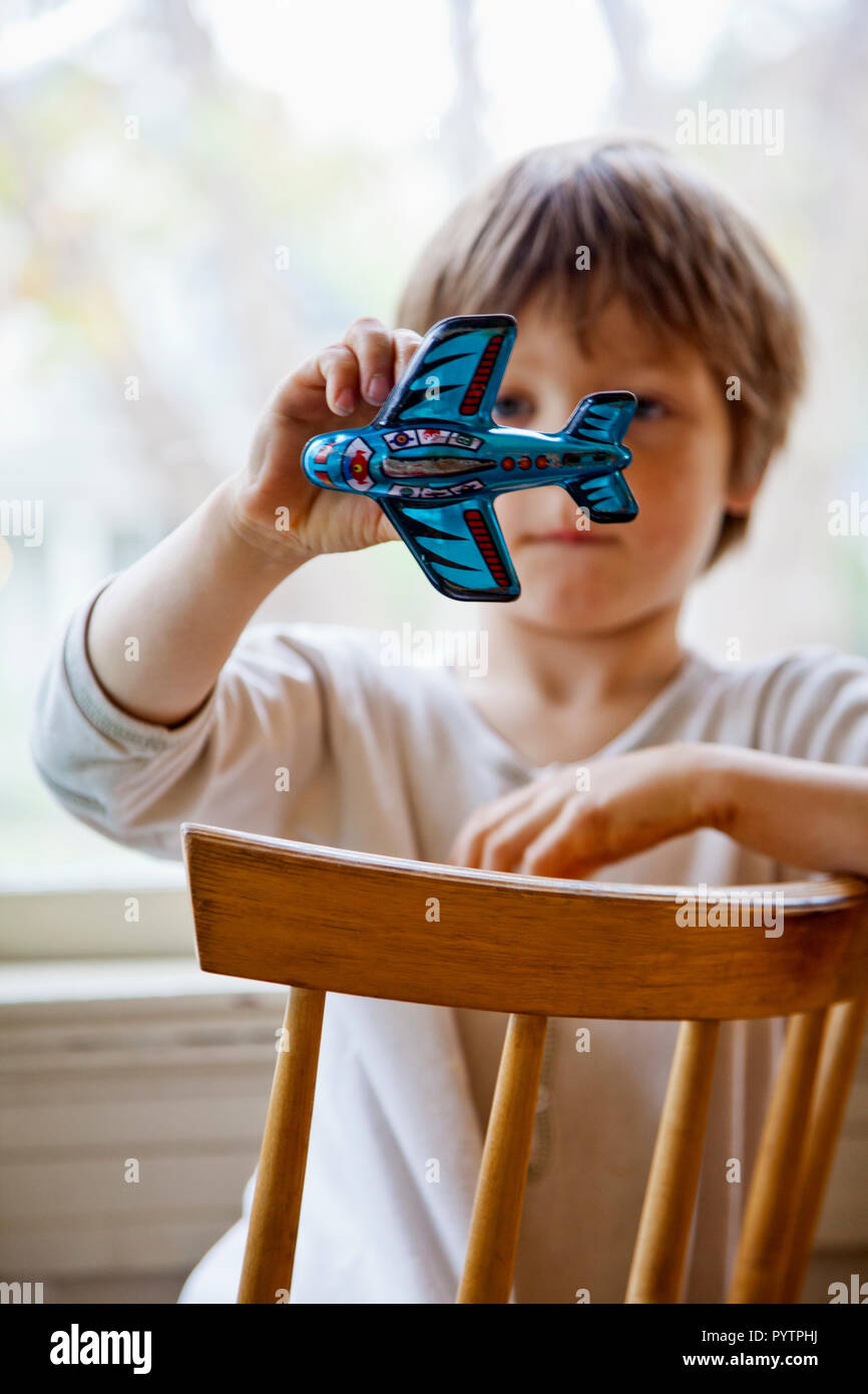 Young boy playing with a toy airplane Stock Photo - Alamy