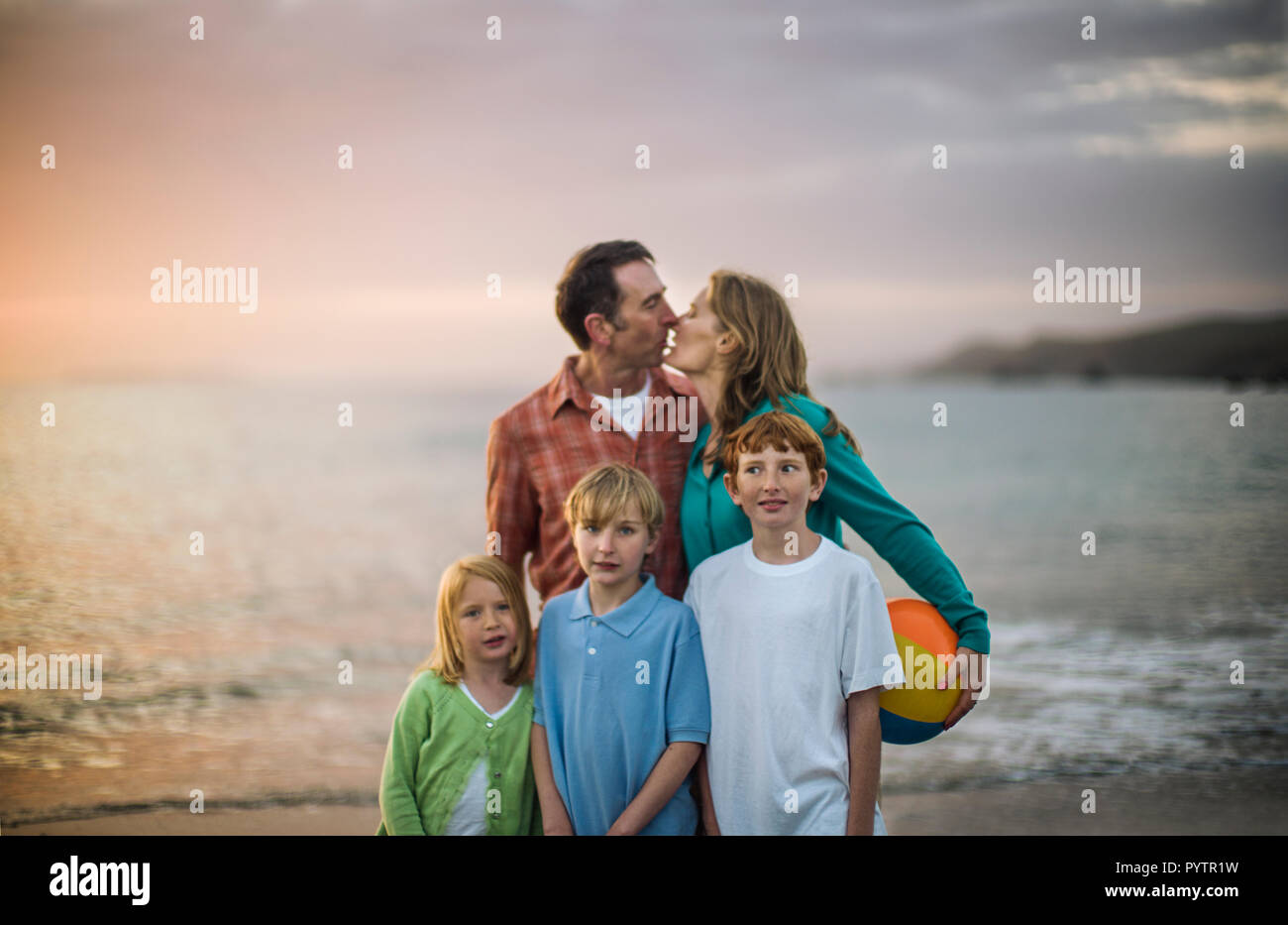 Family standing on the beach hi-res stock photography and images - Alamy