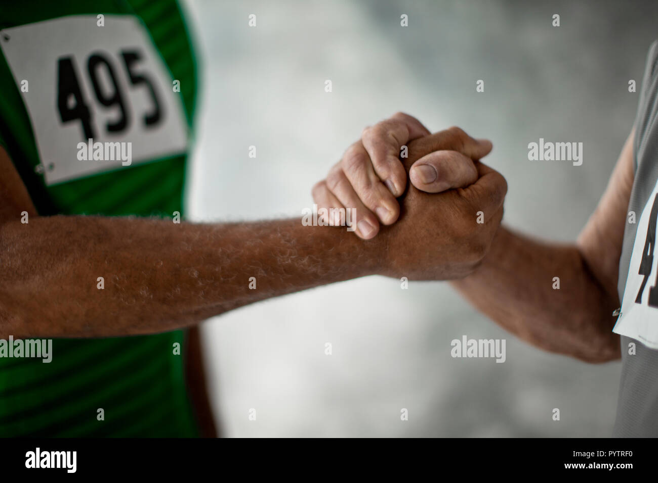 Arms and hands of two senior men wrestling. Stock Photo