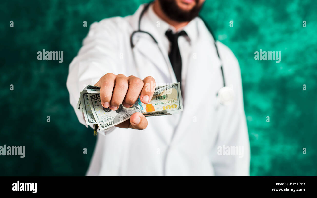 Doctor holding dollar bills close up, corrupcy abstract Stock Photo