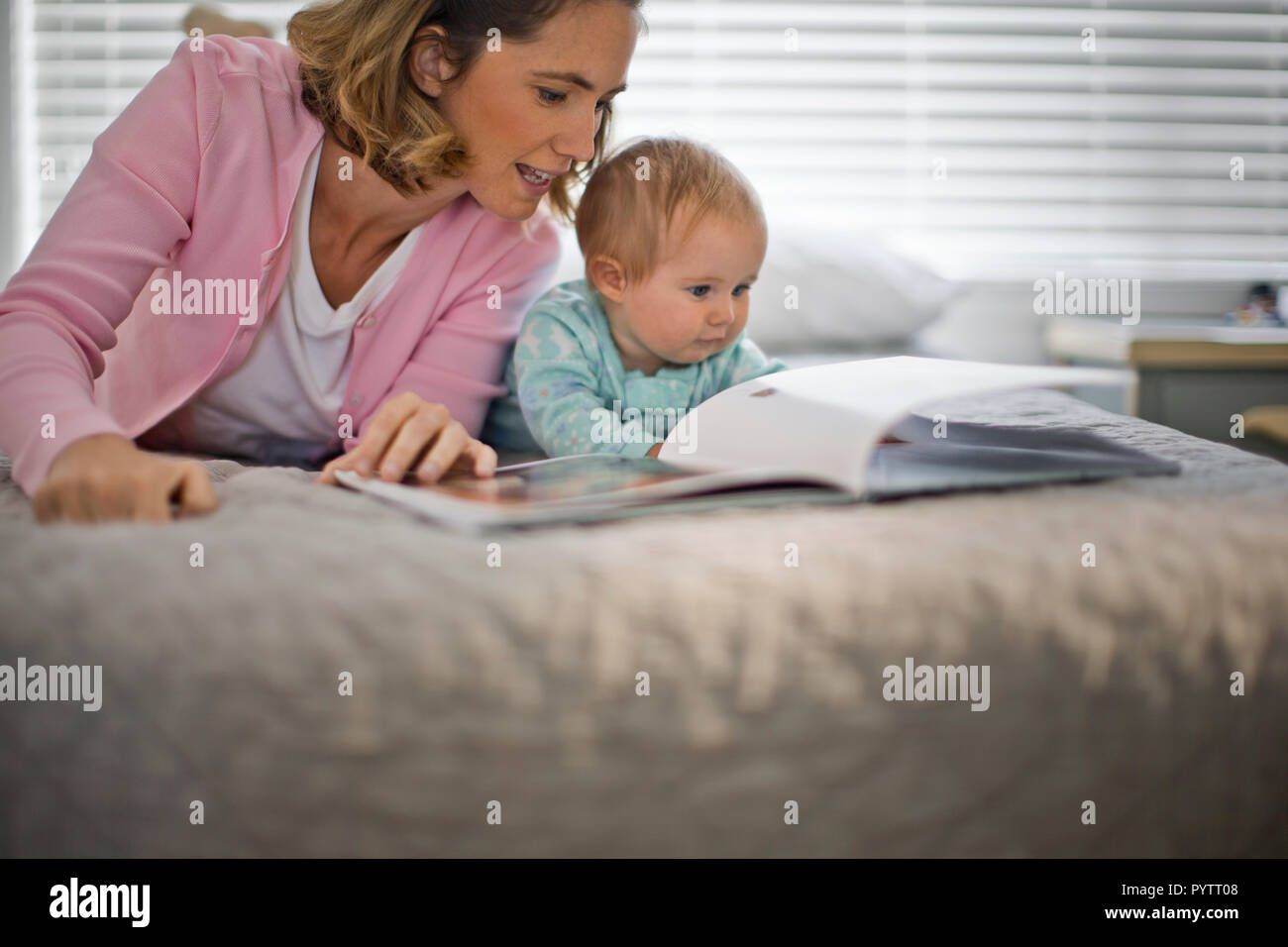 Mother reading a story with her baby daughter. Stock Photo