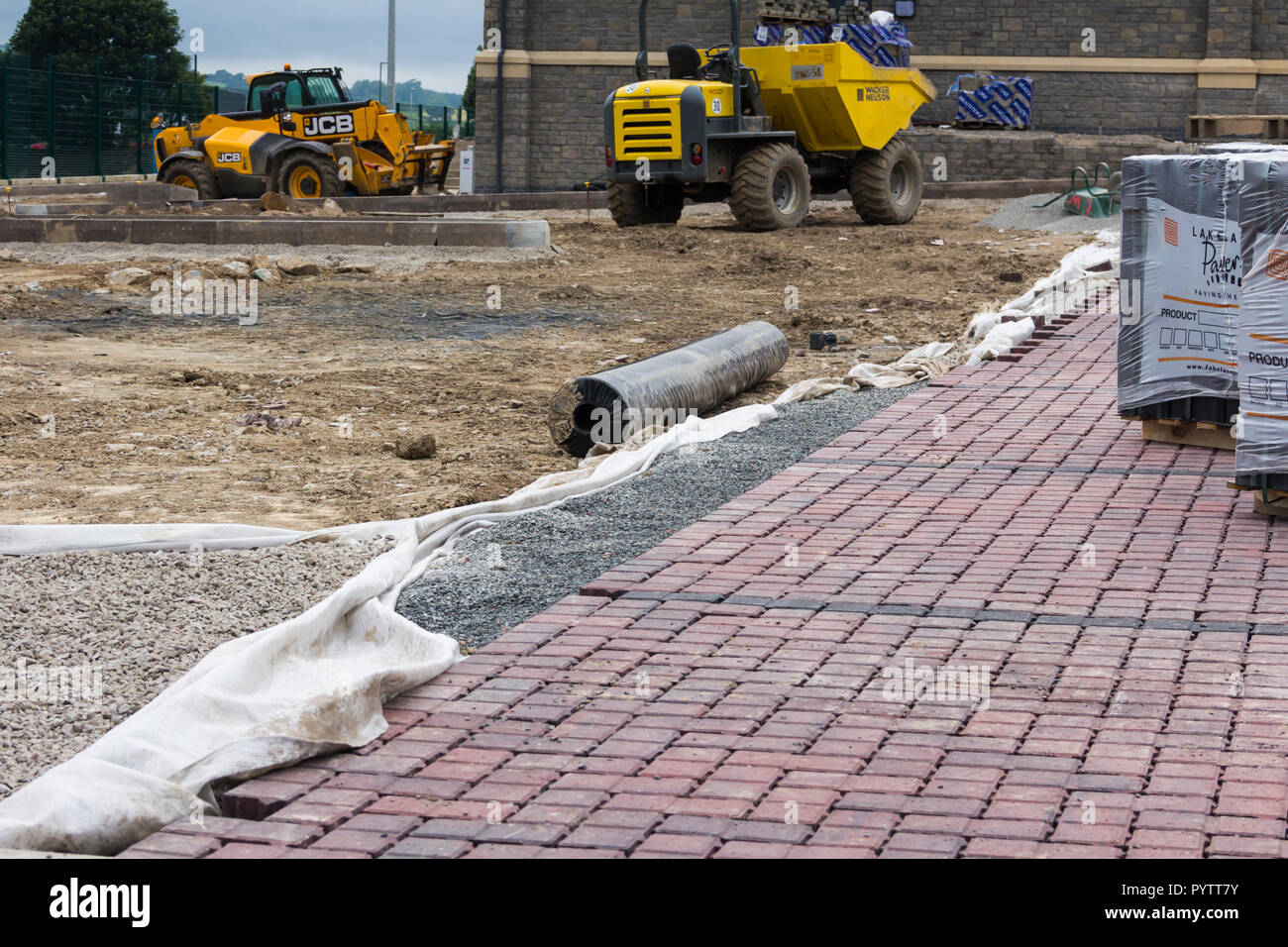 Block paving being laid with sub-base materials visible in the new car park at  Mint Bridge, the new rugby union football ground in Kendal, Cumbria.   Stock Photo
