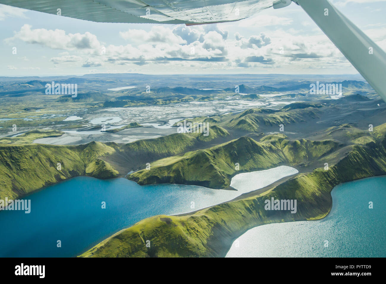 aerial landscape of nature in Iceland, volcanic mountains and lakes in highlands from small airplane Stock Photo