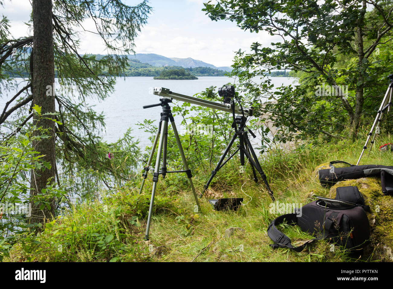 Timelapse setup. A Canon Powershot camera is mounted on a home-made motorised camera slider, on the banks of Derwentwater for timelapse filming. Stock Photo