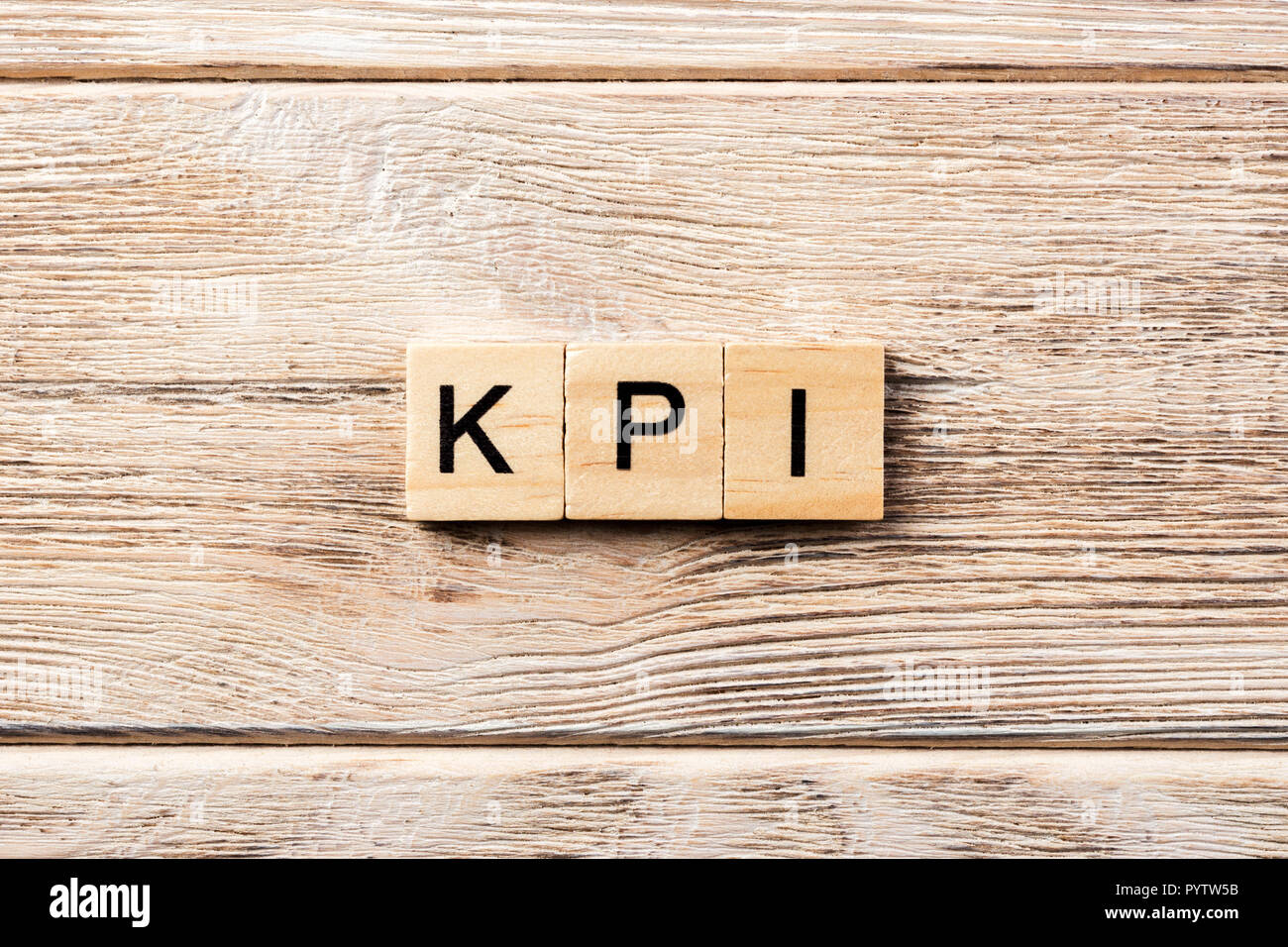 kpi word written on wood block. kpi text on table, concept. Stock Photo