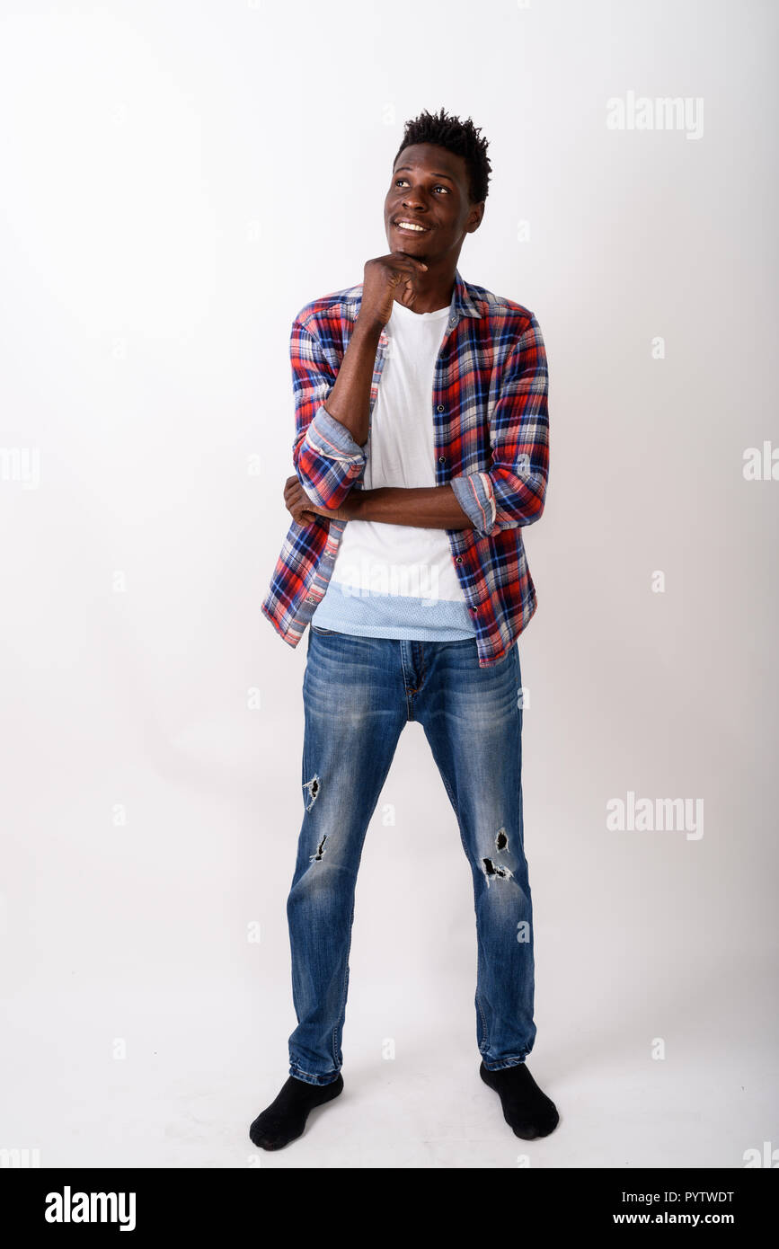 Full body shot of young happy black African man smiling and stan Stock Photo