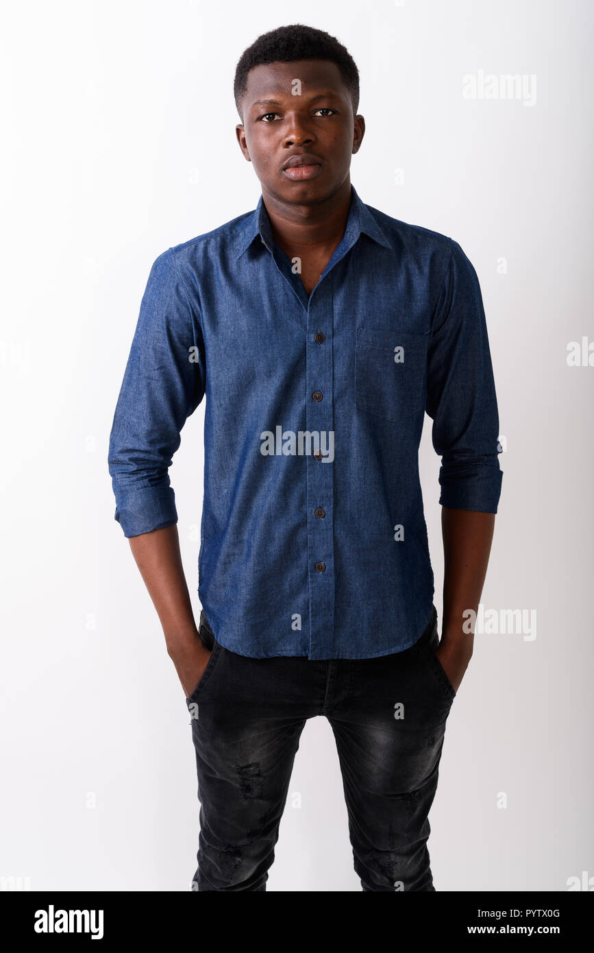 Studio shot of young black African man standing with hands on po Stock ...