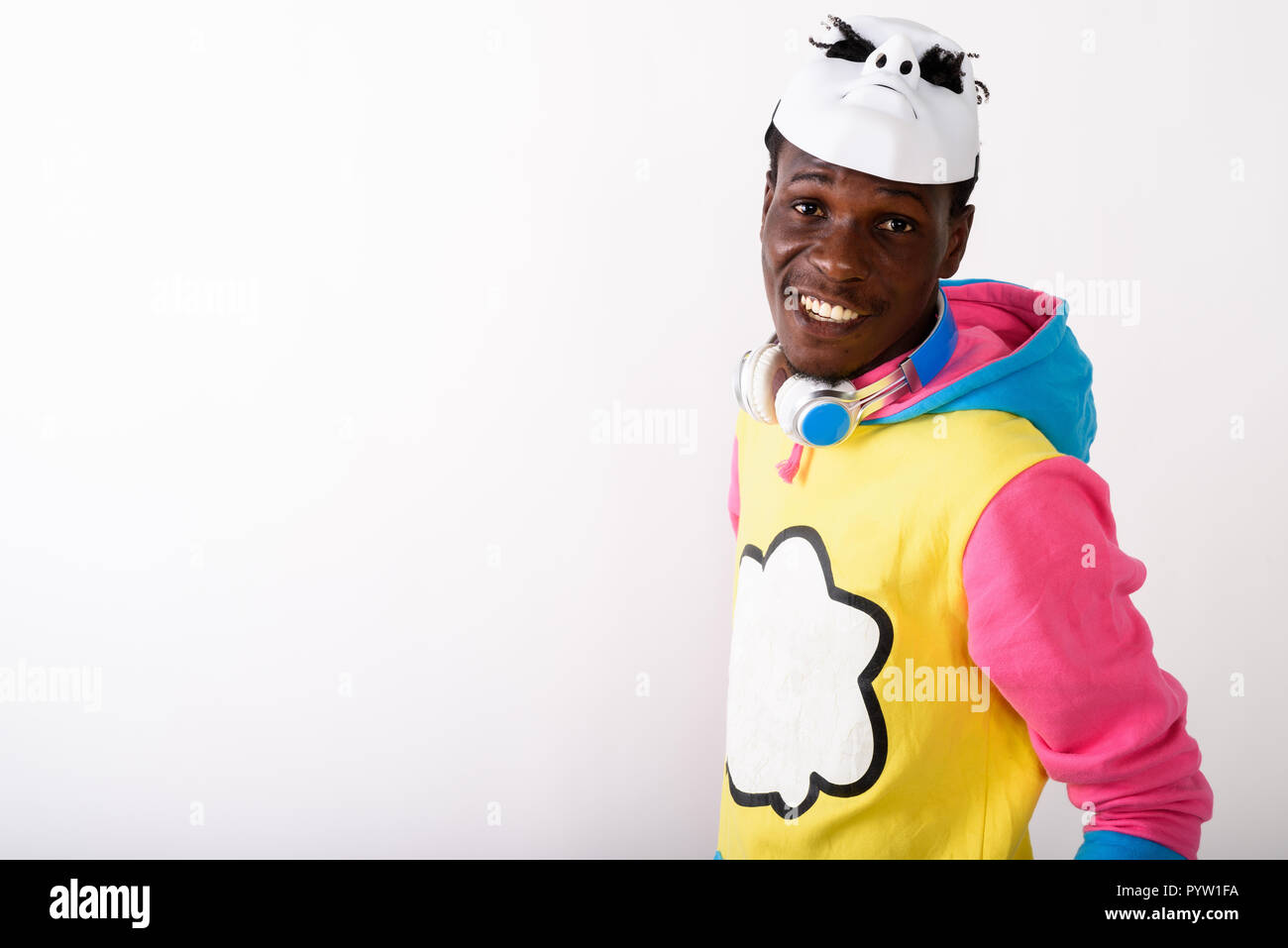Studio shot of young happy black African man smiling while weari Stock Photo