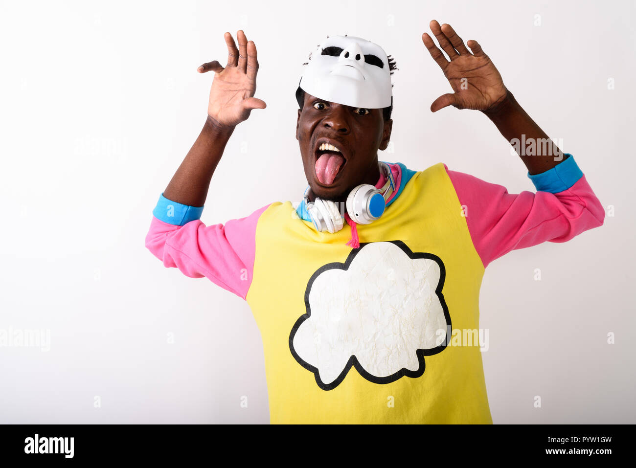Portrait of young black African man sticking tongue out while Stock Photo