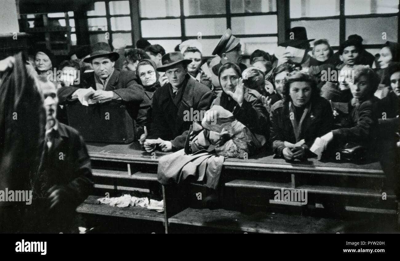 People at the pawn shop to reclaim winter clothes, Budapest, Hungary 1956 Stock Photo
