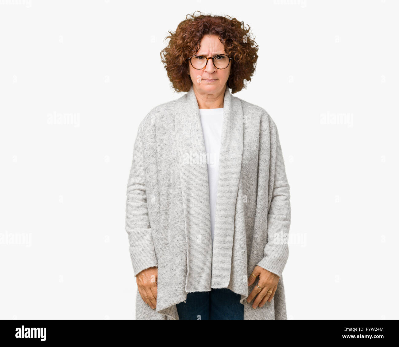 Beautiful middle ager senior woman wearing jacket and glasses over isolated background skeptic and nervous, frowning upset because of problem. Negativ Stock Photo