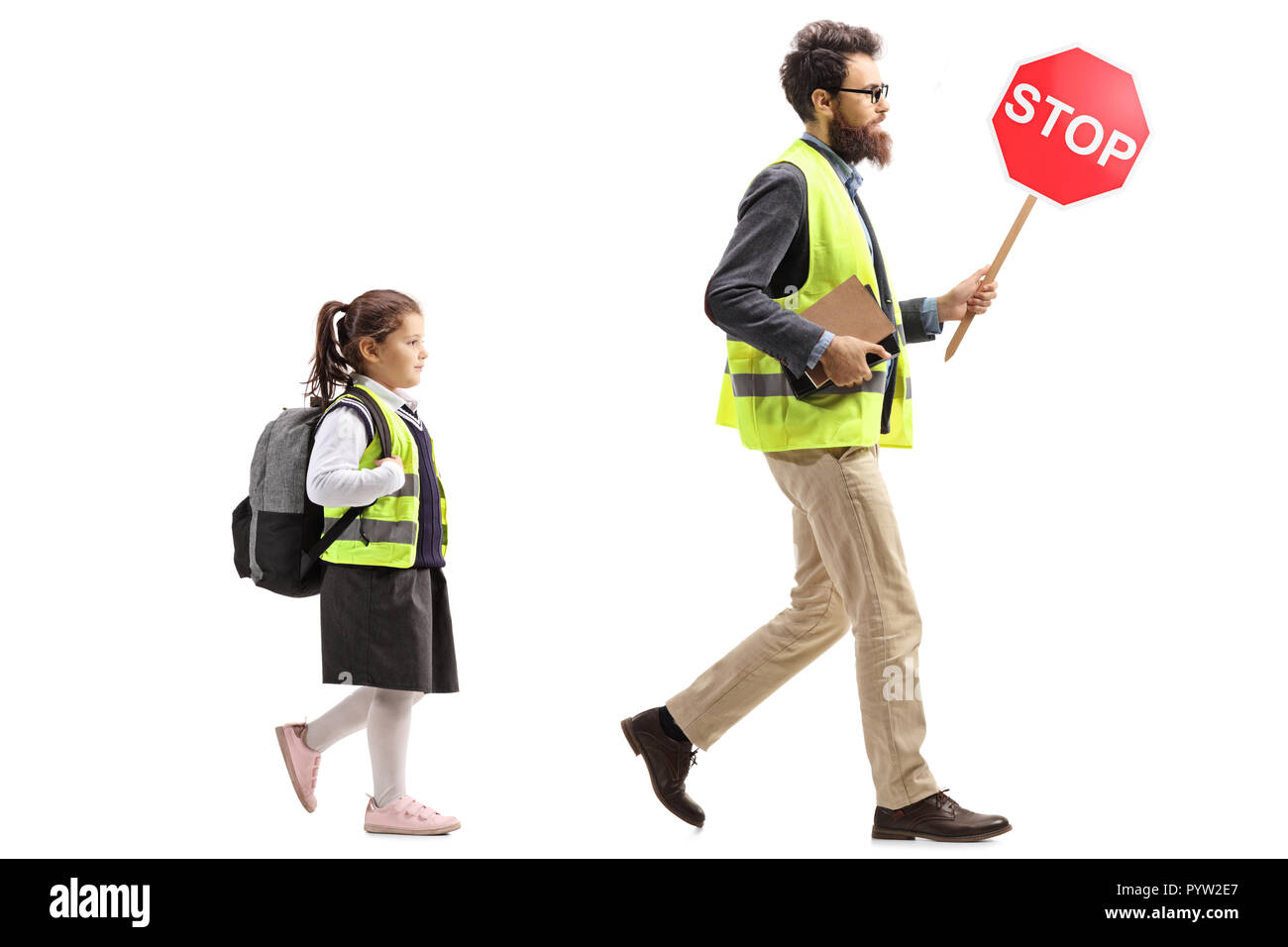 Full length shot of a schoolgirl walking in a safety vest and a man holding a stop traffic sign isolated on white background Stock Photo