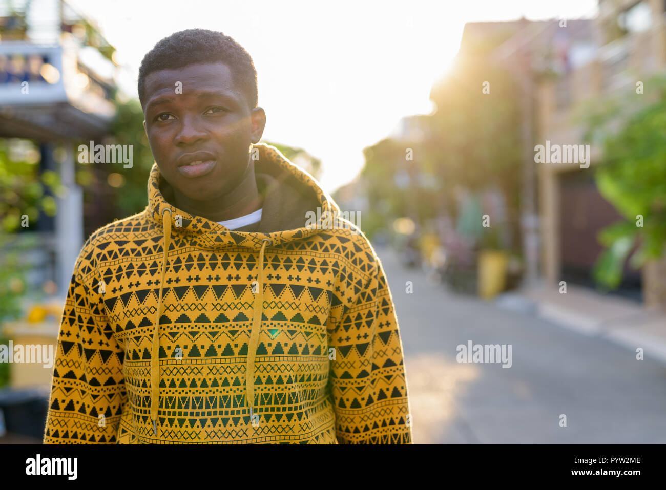 Young black African man thinking while looking at distance and w Stock Photo