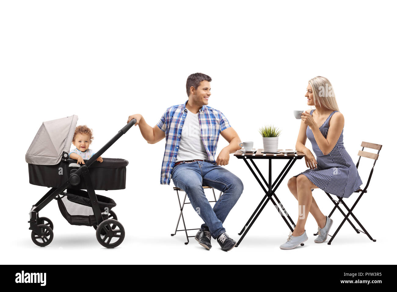 Young family of a mother, father and a baby in a stroller sitting in a cafe isolated on white background Stock Photo