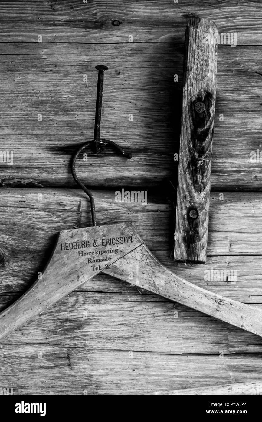 Old wooden cloths hanger on a wall in an old Swedish farm in northern Sweden Stock Photo
