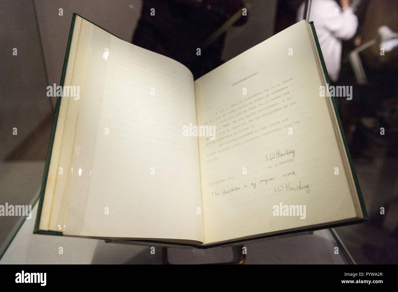 London, Britain. 30th Oct, 2018. A copy of Stephen Hawking's Cambridge University Ph.D. thesis is seen during a photocall for an online auction in London, Britain, on Oct. 30, 2018. An online sale of 22 items from the late physicist Stephen Hawking by auctioneer Christie's will open for bids on Oct. 31. The auction will include some of Hawking's complex scientific papers, one of his iconic wheelchairs and a script from the famous TV comedy show 'The Simpsons.' Credit: Ray Tang/Xinhua/Alamy Live News Stock Photo