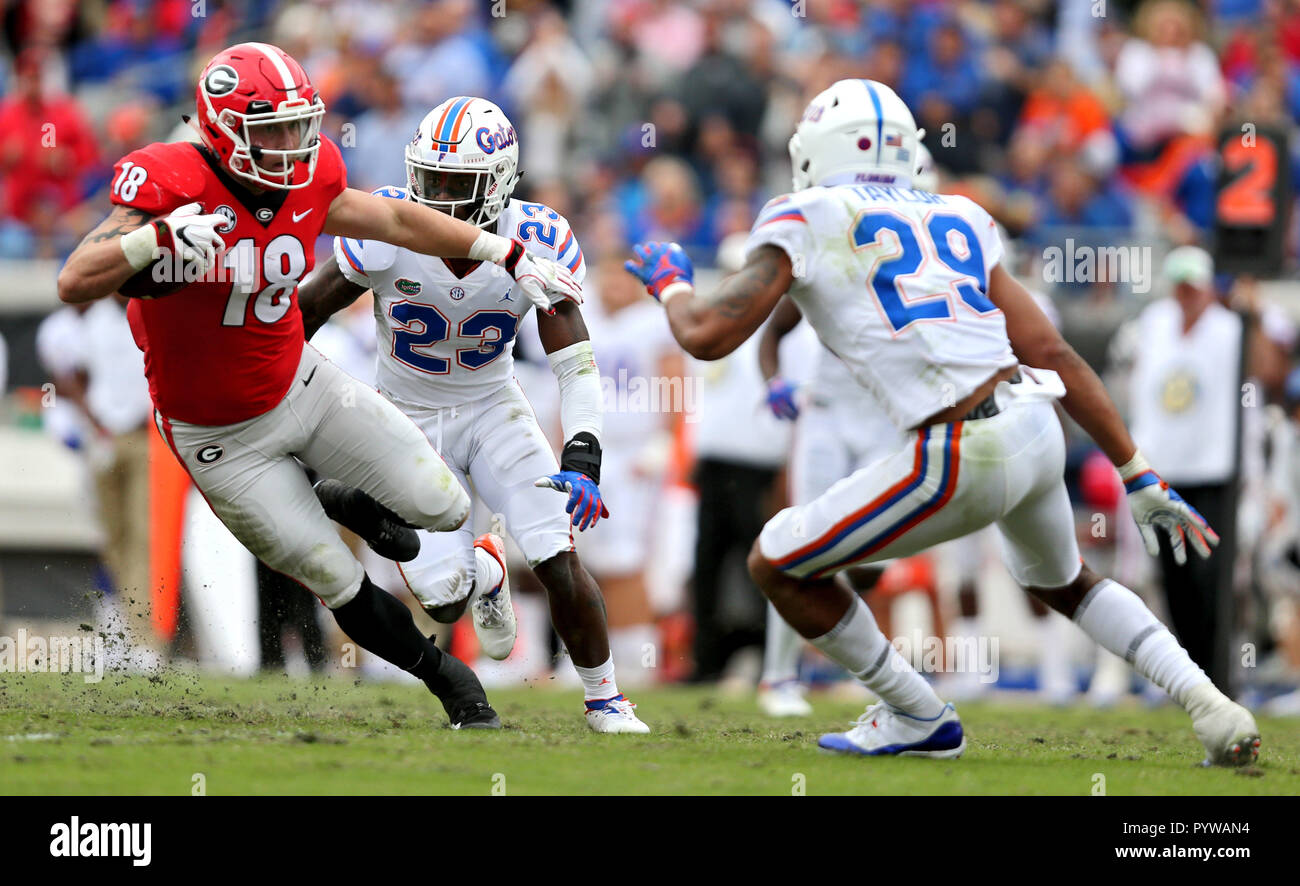 Oct 27 - Jacksonviille, FL, U.S.: Georgia Bulldogs tight end Isaac Nauta (18) runs back a punt as Florida Gators defensive back Jeawon Taylor (29) and Florida Gators defensive back Chauncey Gardner-Johnson (23) defend. The Florida - Georgia football game on TIAA Bank Field in Jacksonville, Florida on Saturday October 27, 2018. (Gary Lloyd McCullough/Cal Sport Media) Stock Photo