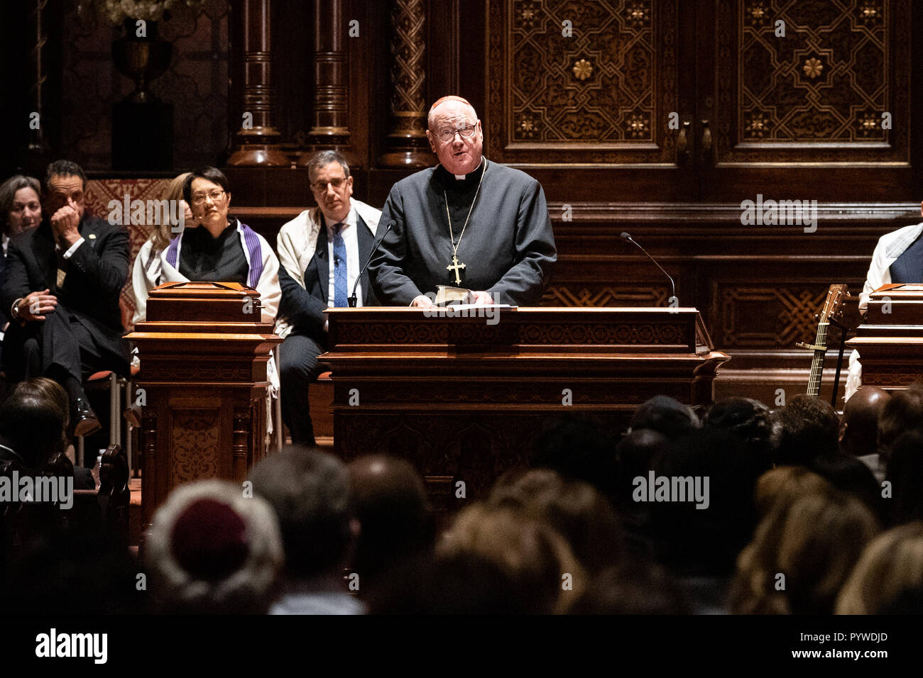 New York, New York, USA. 30th Oct, 2018. Cardinal Timothy Dolan speaking at the interfaith prayer vigil for the shooting at the Tree of Life Synagogue in Pittsburgh, Pennsylvania (October 27) at the Central Synagogue in New York City. Credit: SOPA Images Limited/Alamy Live News Stock Photo