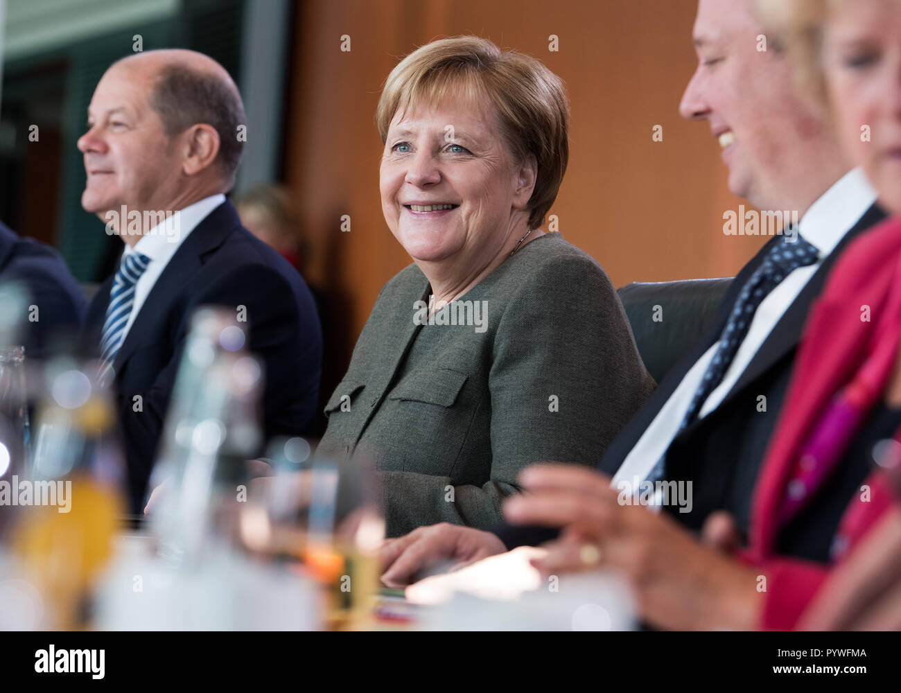 Berlin, Germany. 31st Oct, 2018. Federal Chancellor Angela Merkel (CDU) sits in the Federal Chancellery at the beginning of the Federal Cabinet meeting between Olaf Scholz (l, SPD), Federal Minister of Finance, Helge Braun (2nd from right, CDU), Head of the Federal Chancellery, and Monika Grütters (r, CDU), Minister of State for Culture and Media. The members of the Federal Government are today discussing issues such as organ donations, minimum wages and tax issues. Credit: Bernd von Jutrczenka/dpa/Alamy Live News Stock Photo