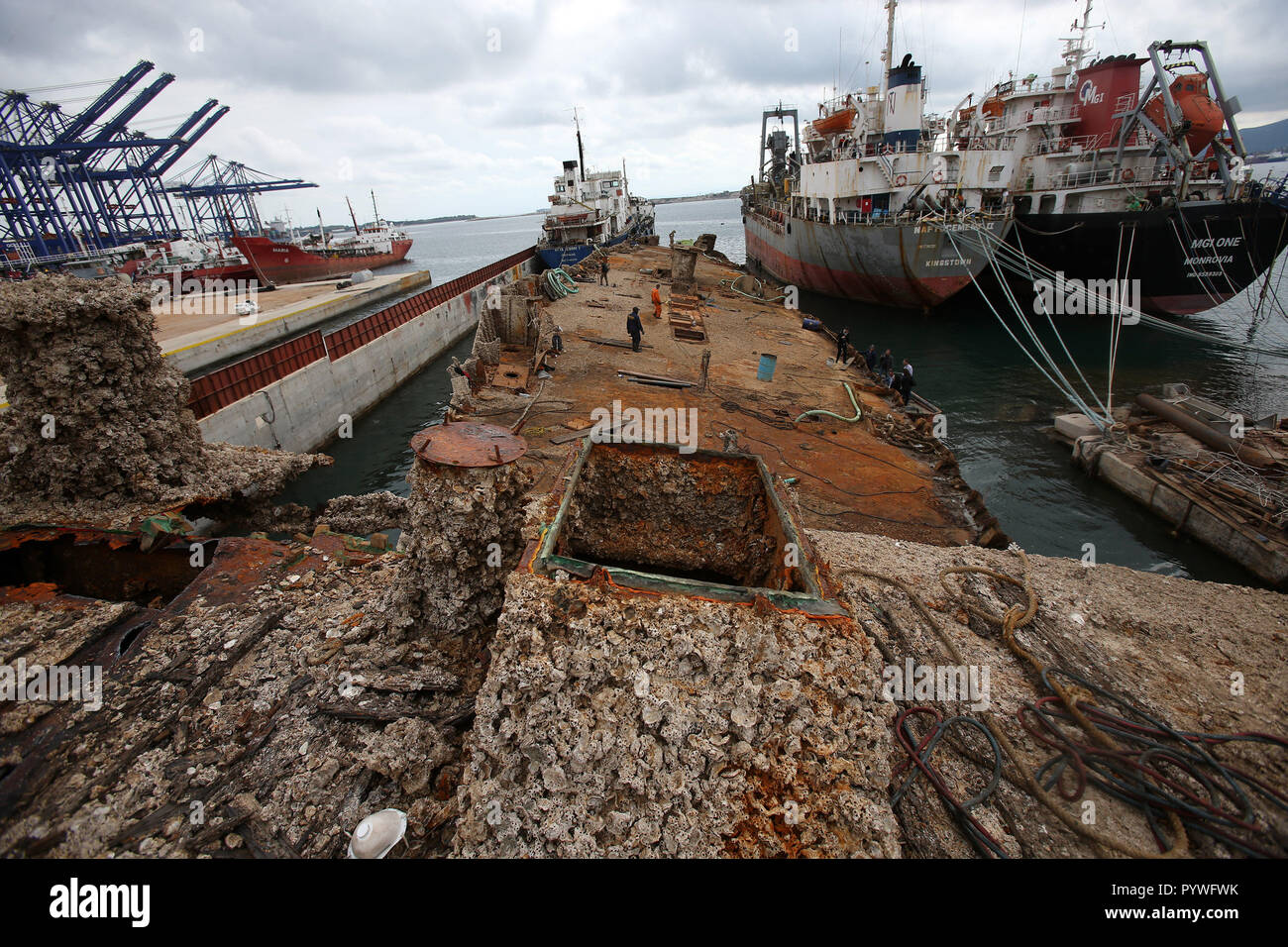 Perama, Greece. 30th Oct, 2018. Workers clear debris from the shipwreck of 'Corfu Island' in the repair zone of Perama, Greece, on Oct. 30, 2018. Thirty two years after she sunk at Dock II of Perama's ship repairs zone while undergoing repairs, 'Corfu Island' was recovered this autumn. The raising and towing of the wreck of the Greek-owned ferry is the first step of a wider project launched by the Greek authorities to clear the Saronic Gulf waters from dozens of such shipwrecks, officials said here on Tuesday. Credit: Marios Lolos/Xinhua/Alamy Live News Stock Photo