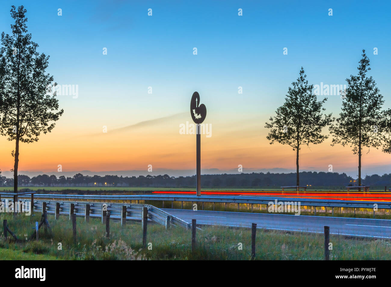 Drachten, Netherlands - June 9, 2016: Regional highway N381 at dusk with proven functional wildlife crossing hop over aids for bats and birds Stock Photo