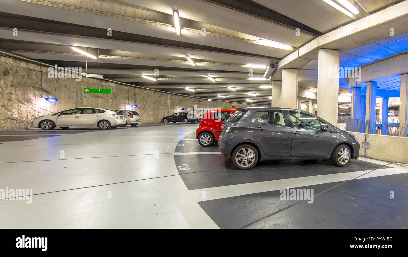 Underground circular parking garage with parked cars Stock Photo