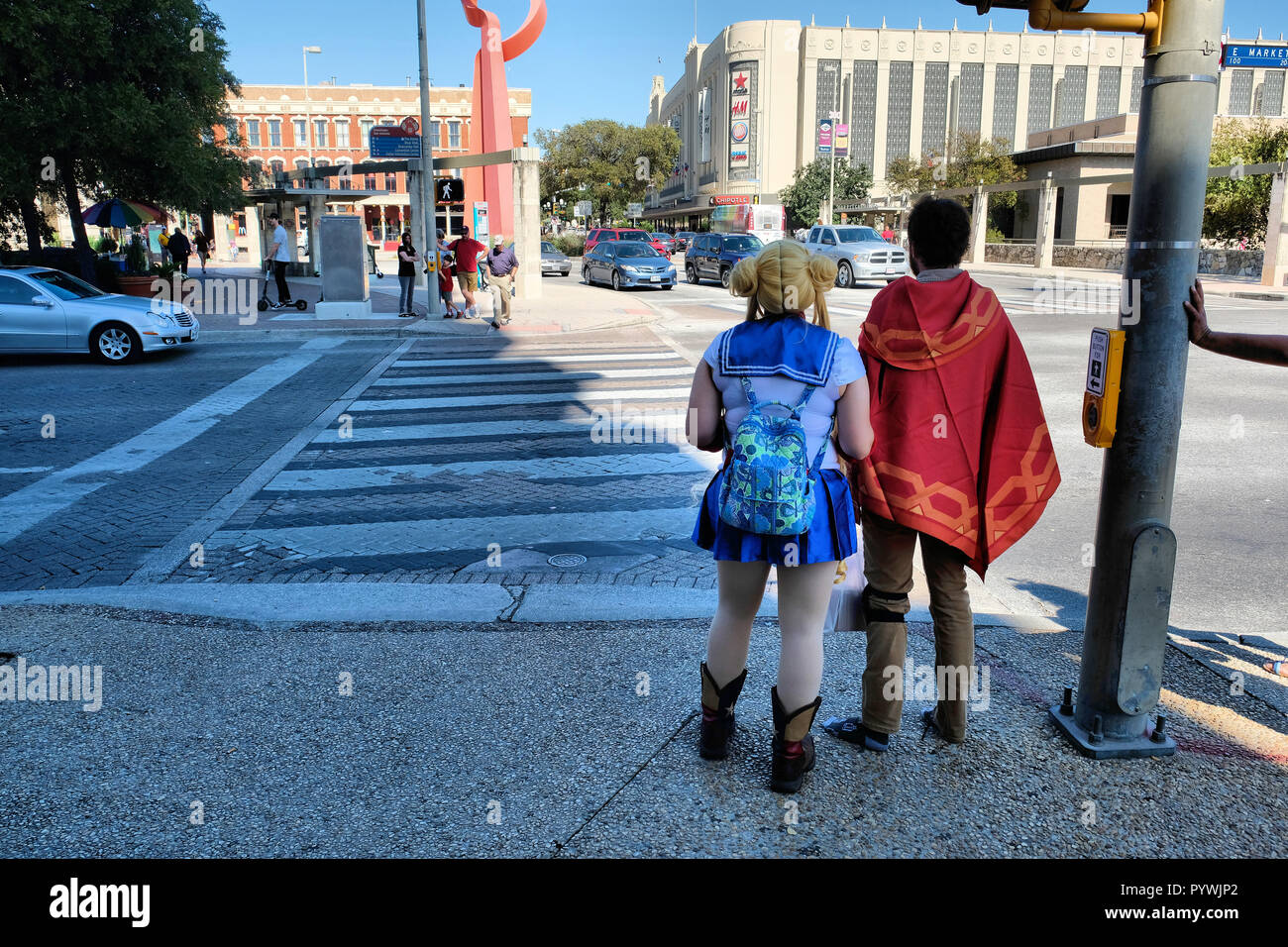 Sailor Moon and escort wait to cross an intersection on the way to the Alamo City Comic-Con at the Alamodome in San Antonio, Texas, USA (27 Oct. 2018) Stock Photo