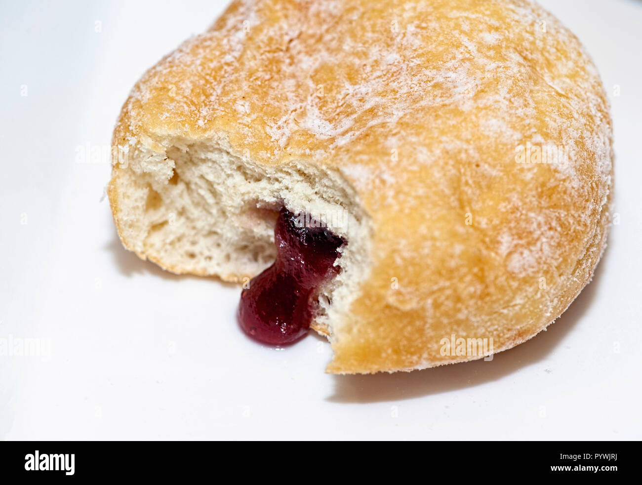 Jam Doughnut with jam oozing out Stock Photo Alamy