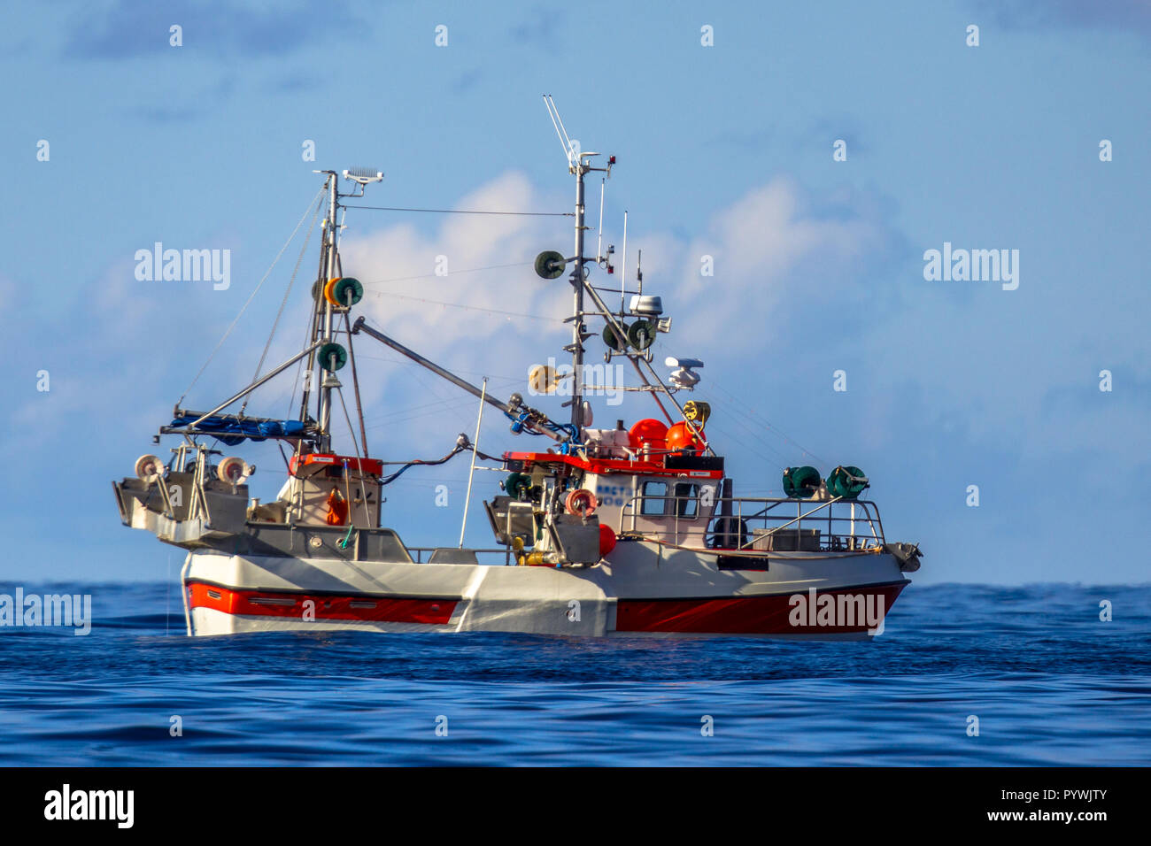 Sustainable Commercial mackerel hook line fishing vessel on blue waters of Norwegian fjord Stock Photo