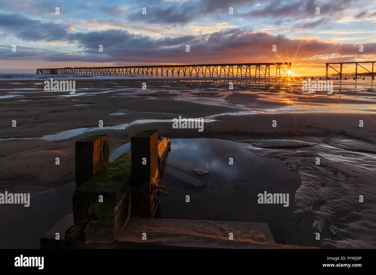 Sunrise Steetley Pier and beach at dawn  on the Durham coast North of Hartlepool in Teesside North East England Stock Photo