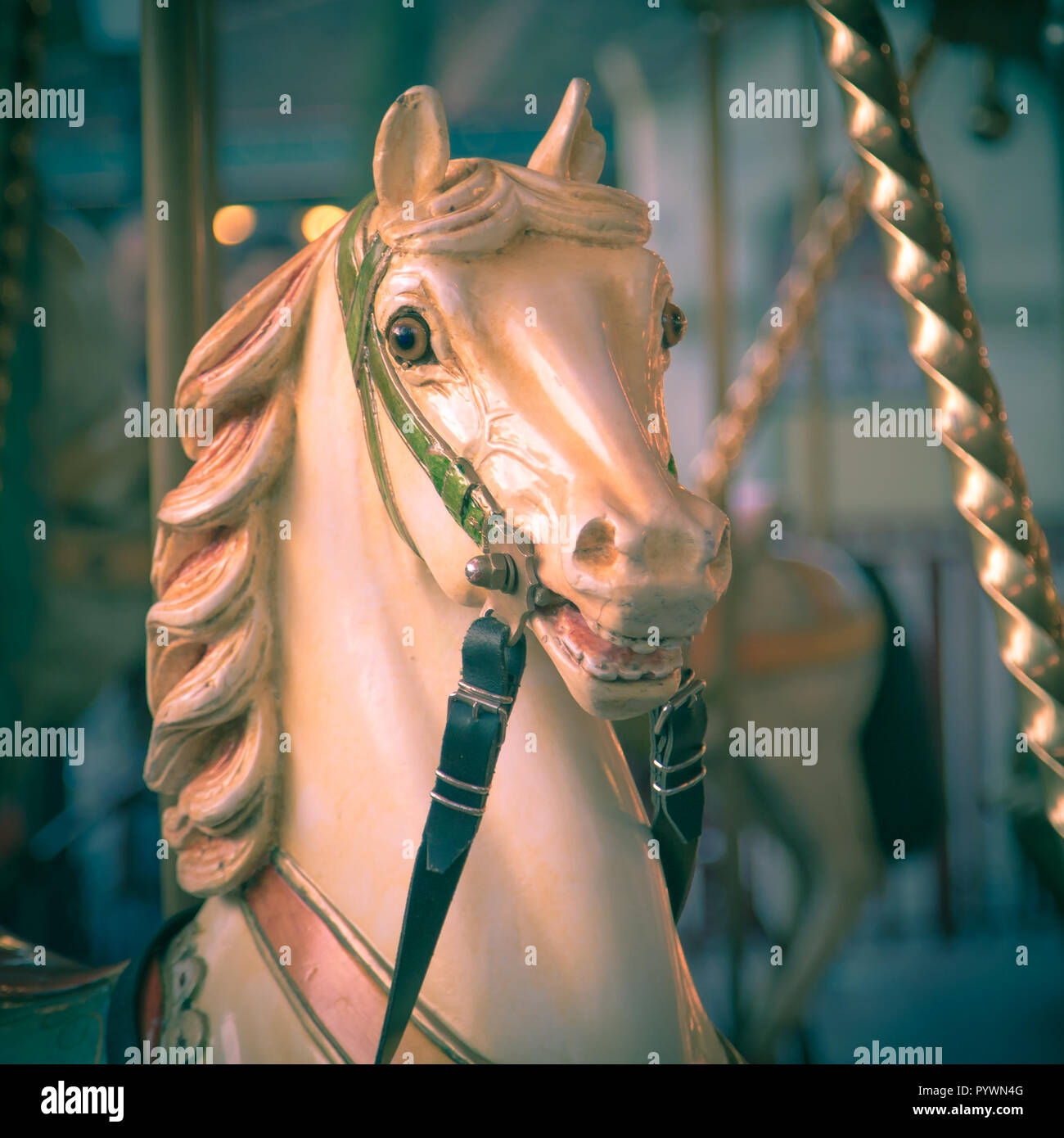 Head of horse in a merry go round on a historic summer funfair with vintage instagram look. Amusement concept Stock Photo