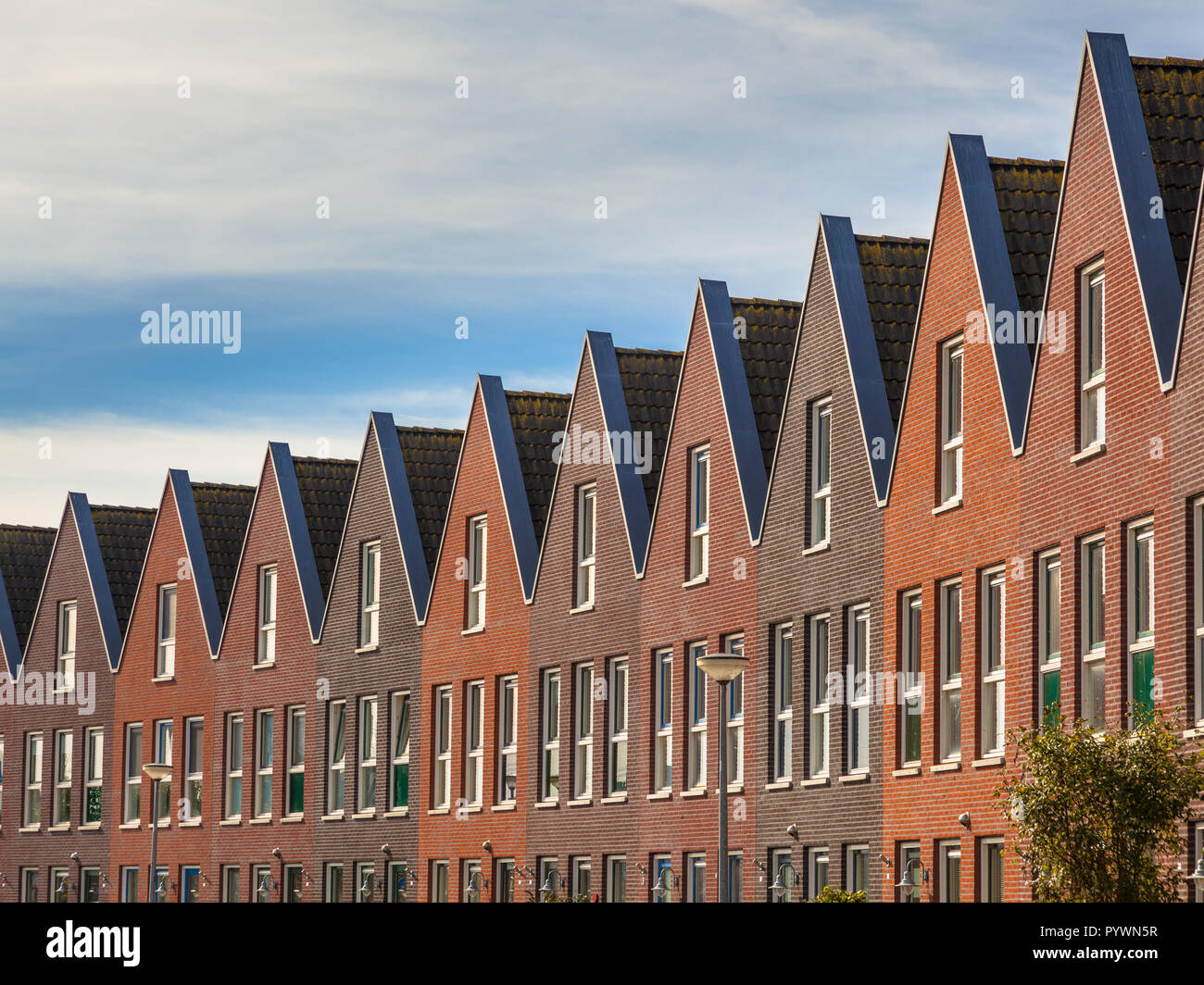 Facades of Modern Real Estate Family houses in a row Stock Photo