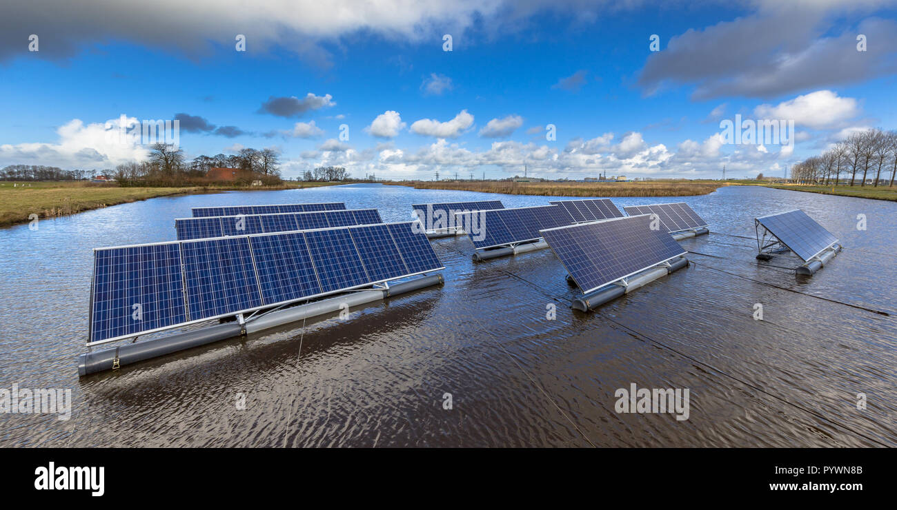 Groups of Floating solar panels on unused water bodies can represent a serious alternative to ground mounted solar systems Stock Photo