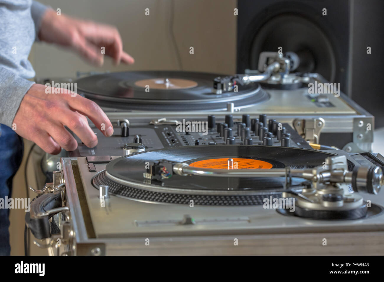 Hands of DJ playing music from vinyl records in his home studio Stock Photo
