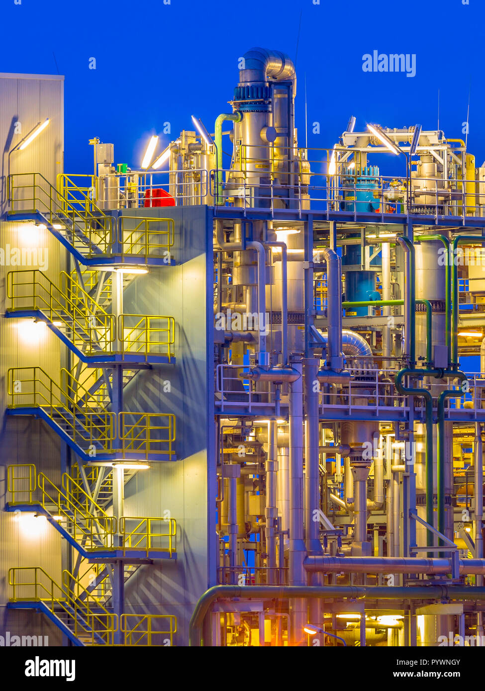 Detail of Heavy chemical plant portrait in twilight in an industrial factory area Stock Photo