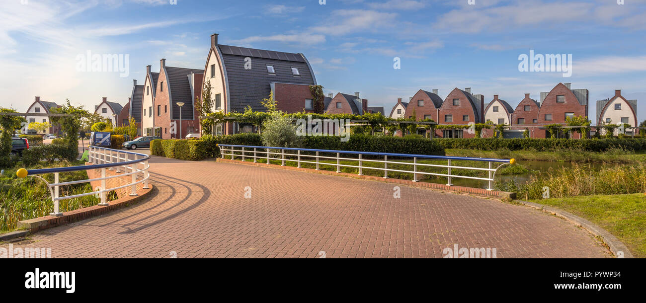 Suburban area with modern family houses in a child-friendly  neighborhood with trees and gardens Stock Photo