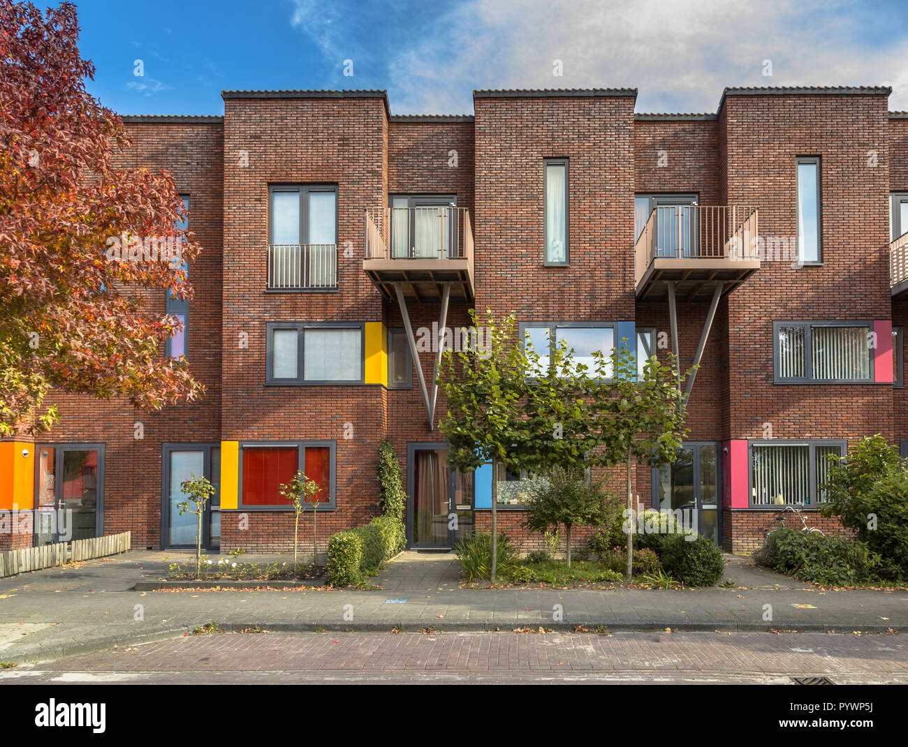 Colorful modern suburban family rowhouses in a lively proper