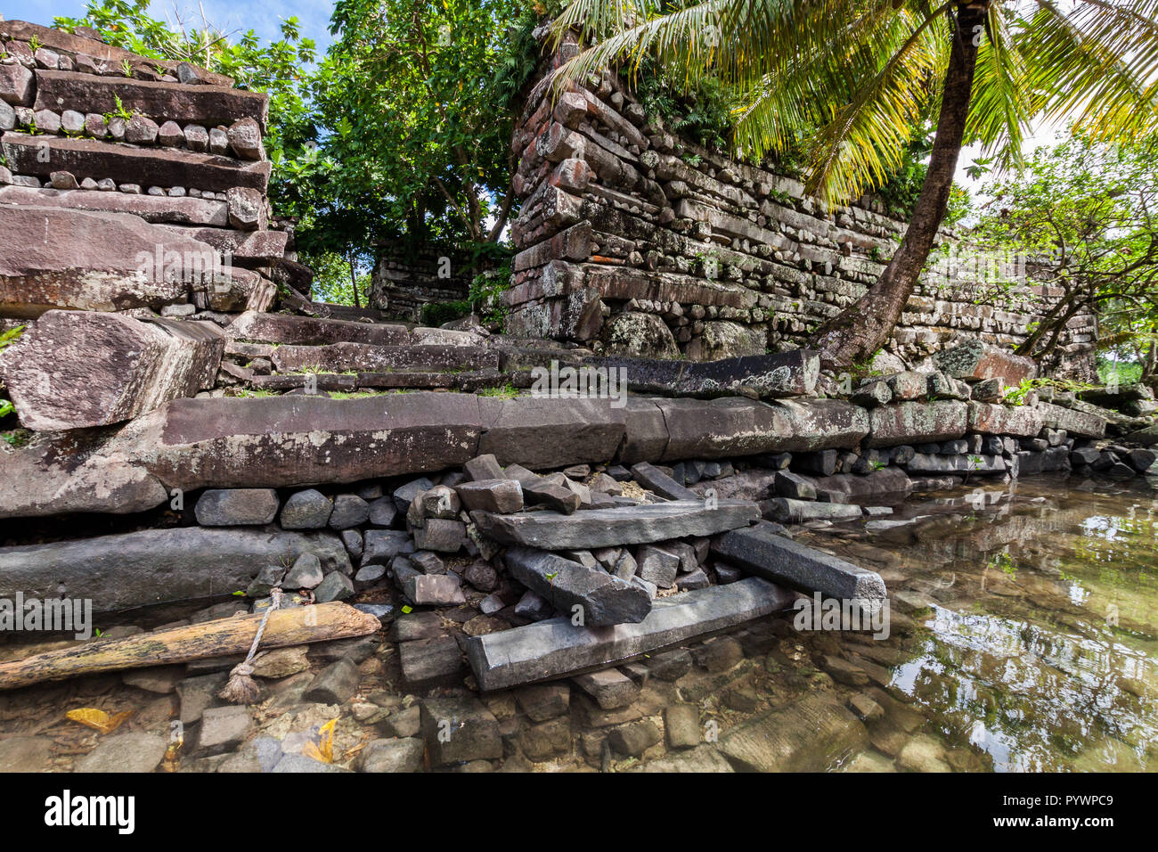 Main gates to the walls of Nan Madol - prehistoric ruined stone city built of basalt slabs on islands and canals, overgrown with palms. Pohnpei, Micronesia, Oceania Stock Photo