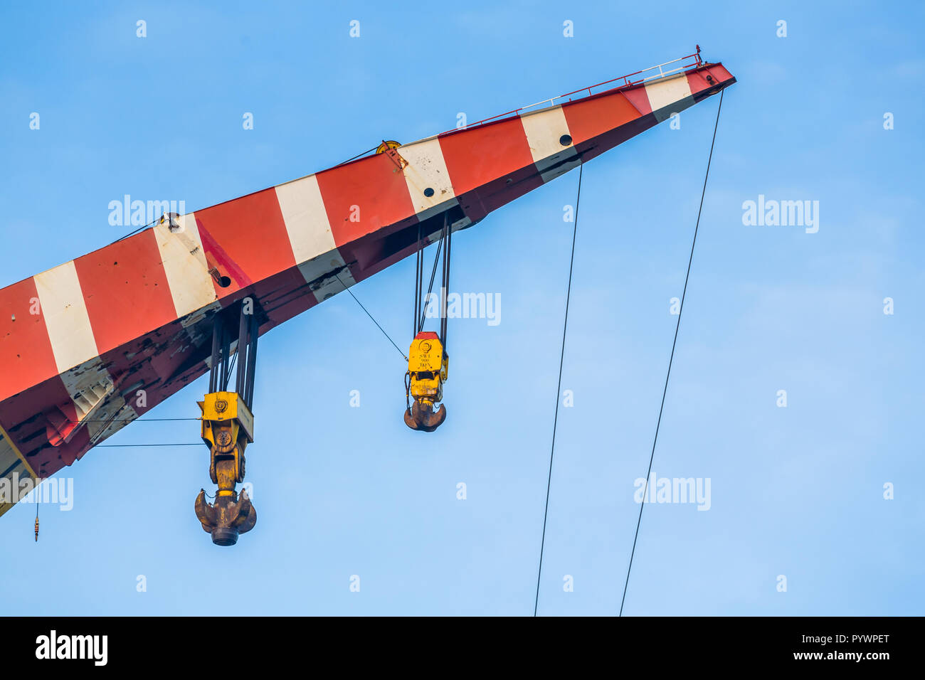 Crane top in red and white danger colors with hooks and cables Stock ...