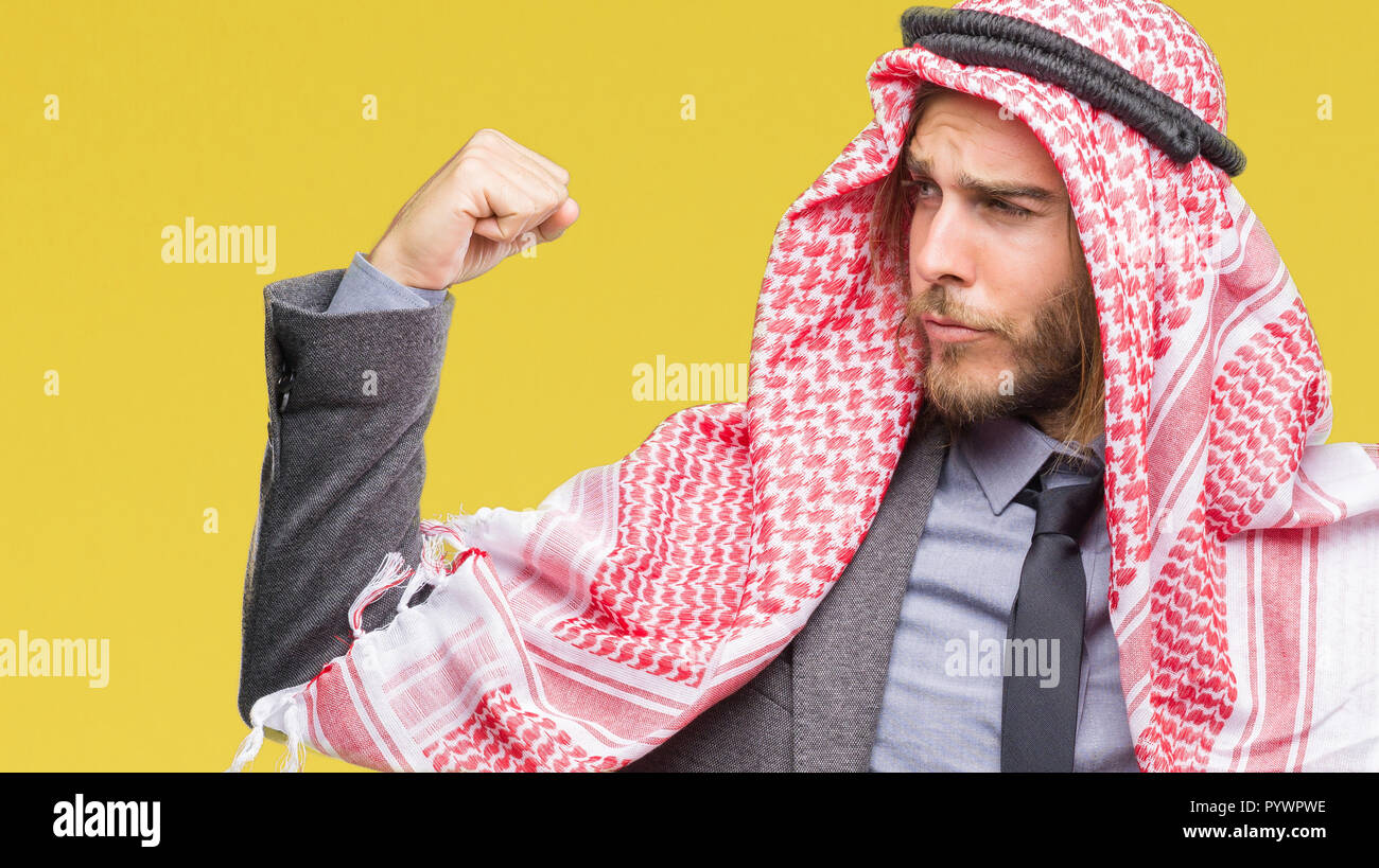 Young handsome arabian man with long hair wearing keffiyeh over isolated  background showing arms muscles smiling proud. Fitness concept Stock Photo  - Alamy