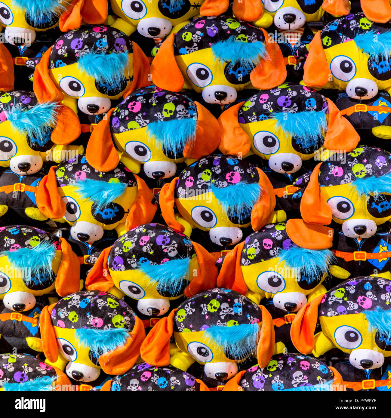 Uniform pattern of cuddly pirate dog animals in bright colors, to be won as a prive on a funfair. Stock Photo