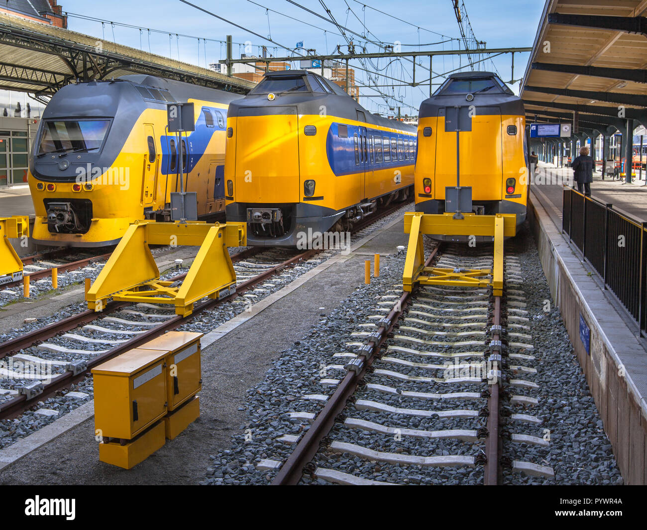 Three large intercity trains on Central Station in Groningen waiting at the platform to leave