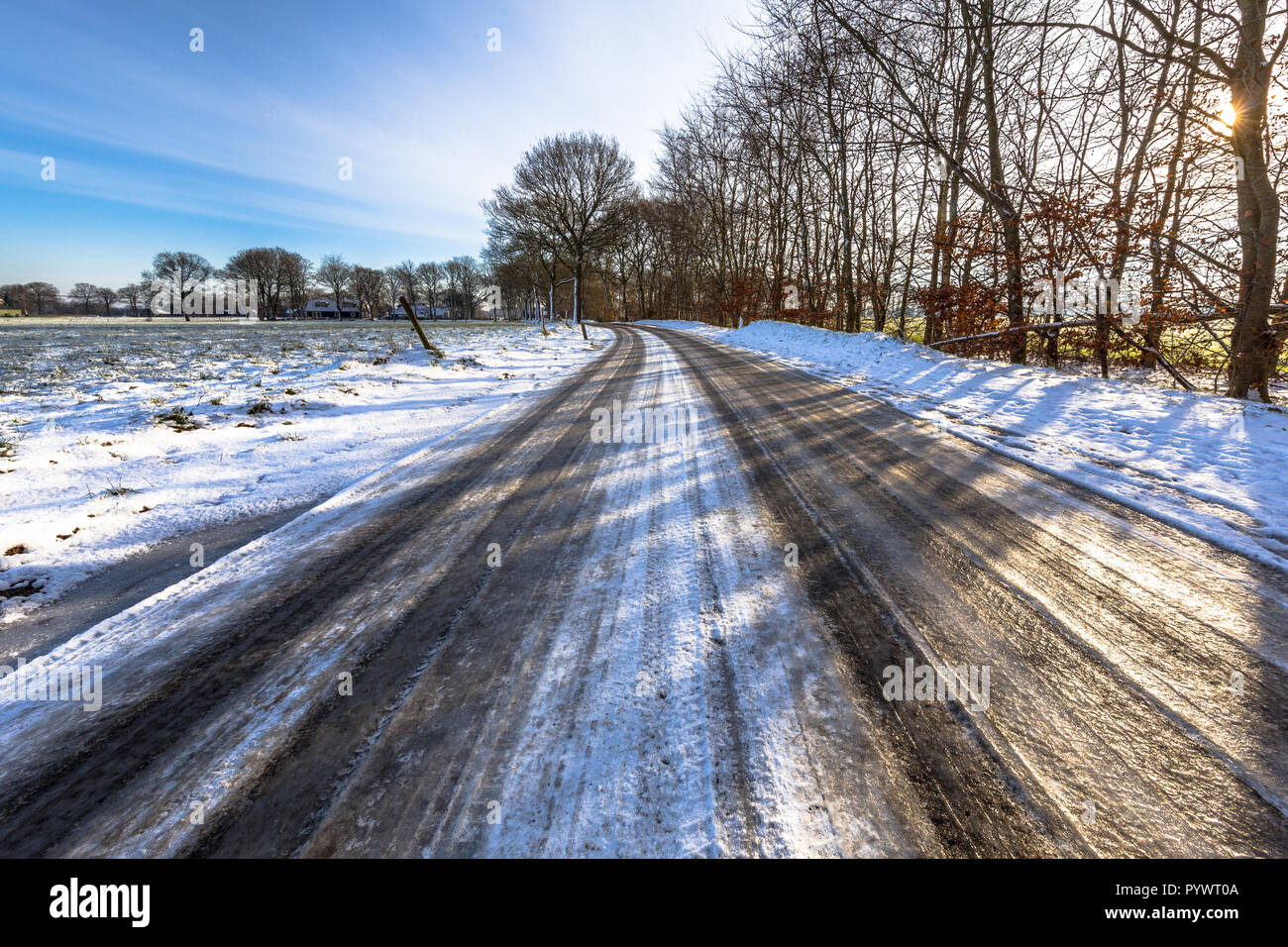 Glazed ice on a road in the Frisian countryside of the Netherlands ...