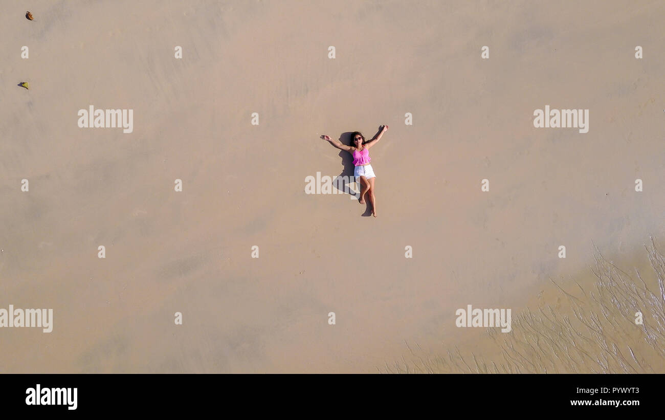 top aerial view of a woman lying on a tropical beach sand Stock Photo ...