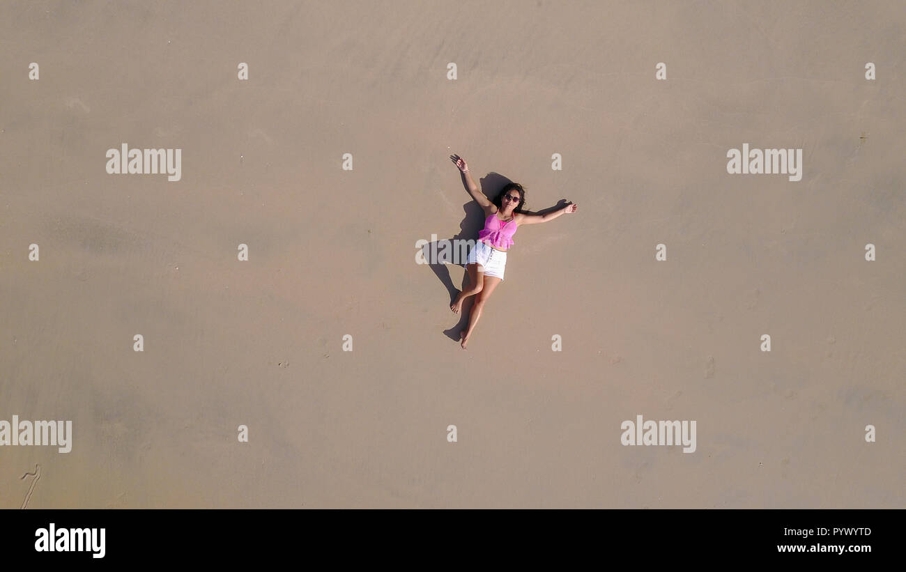 top aerial view of a woman lying on a tropical beach sand Stock Photo ...