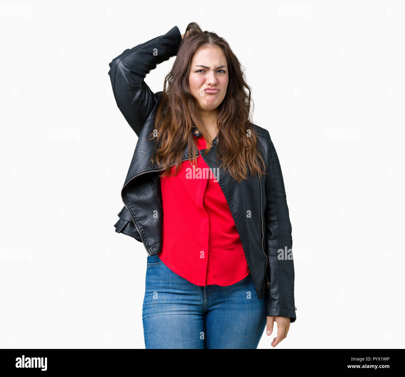 Beautiful plus size young woman wearing a fashion leather jacket over isolated background confuse and wonder about question. Uncertain with doubt, thi Stock Photo