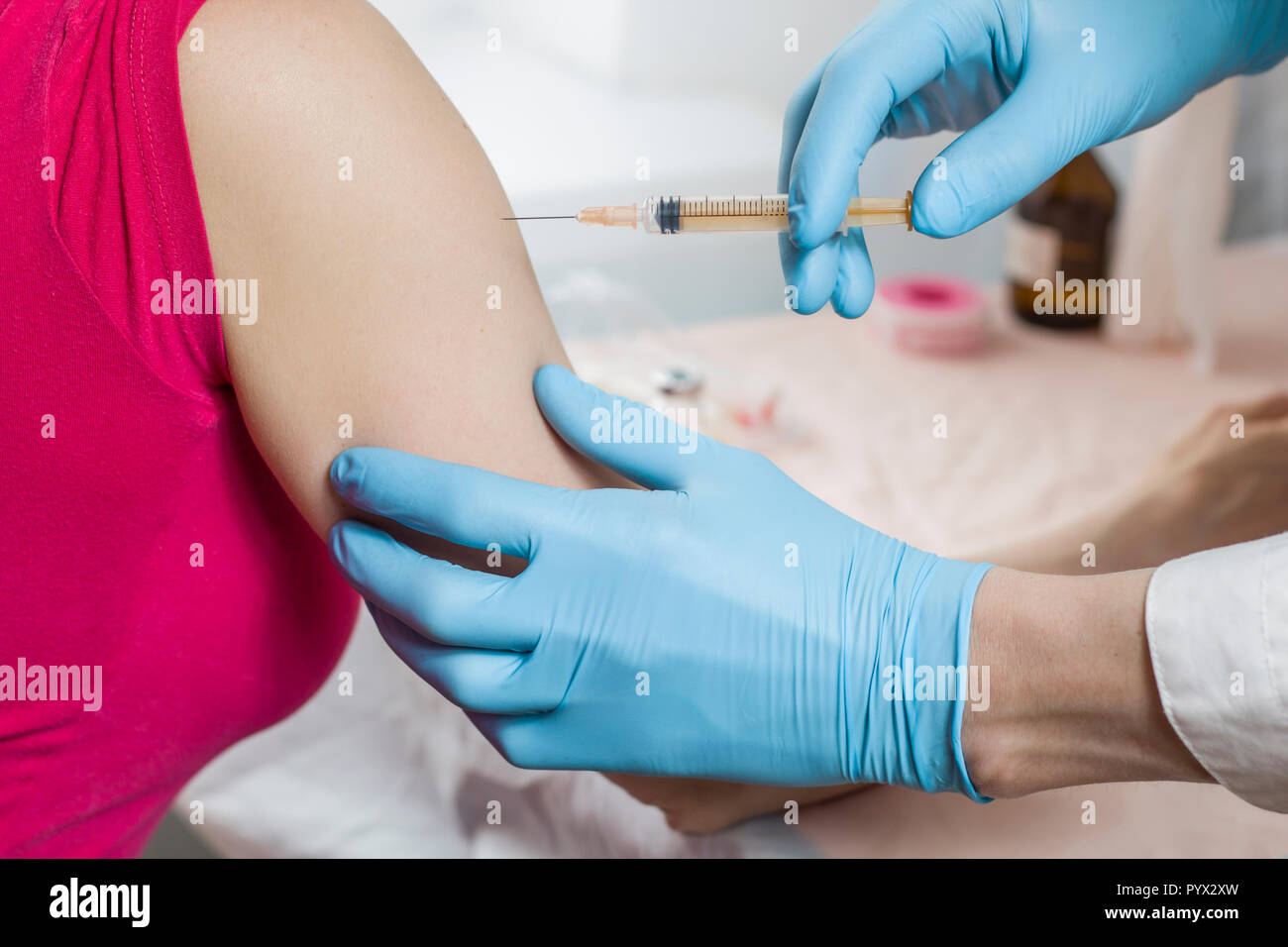The doctor vaccinates with a syringe. Stock Photo
