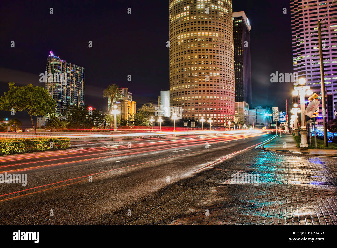 The rush of car lights go by on this rainy night in the city. Stock Photo