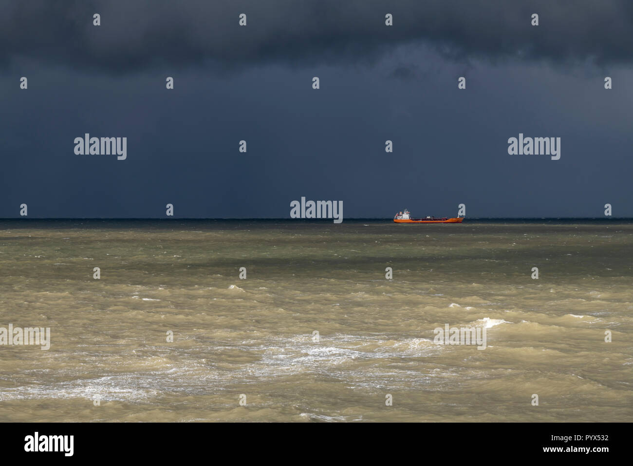 The English Channel seen from Margate seafront - The Bay. Early evening clouds are making the skies dark A gap in the clouds lightens the closer sea. Stock Photo