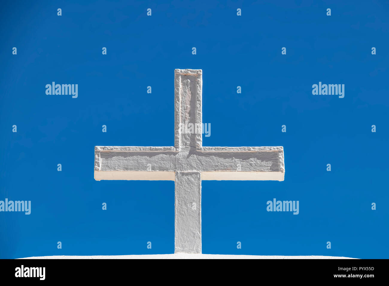 White adobe cross against a very blue sky - closeup Stock Photo